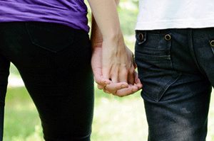 teen couple holding hands