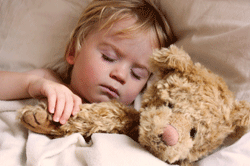 Child sleeping with teddy bear